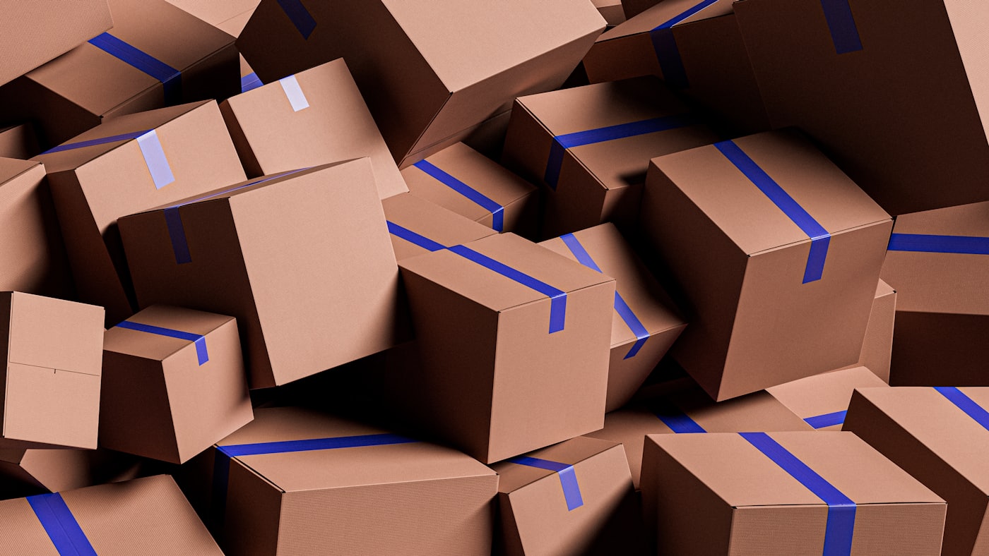 A pile of taped cardboard shipping boxes ready for dispatch